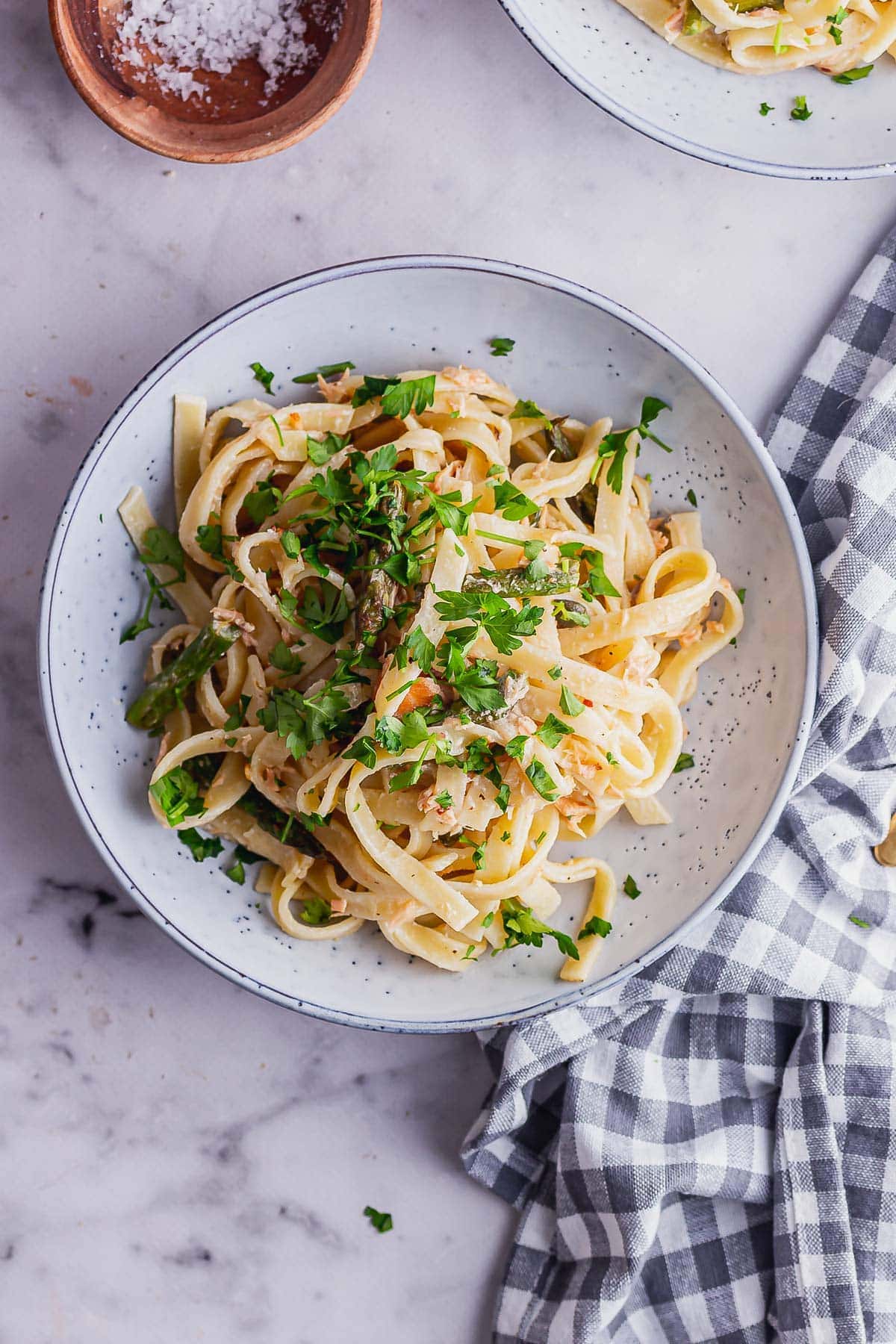 Overhead shot of smoked salmon pasta in a blue bowl