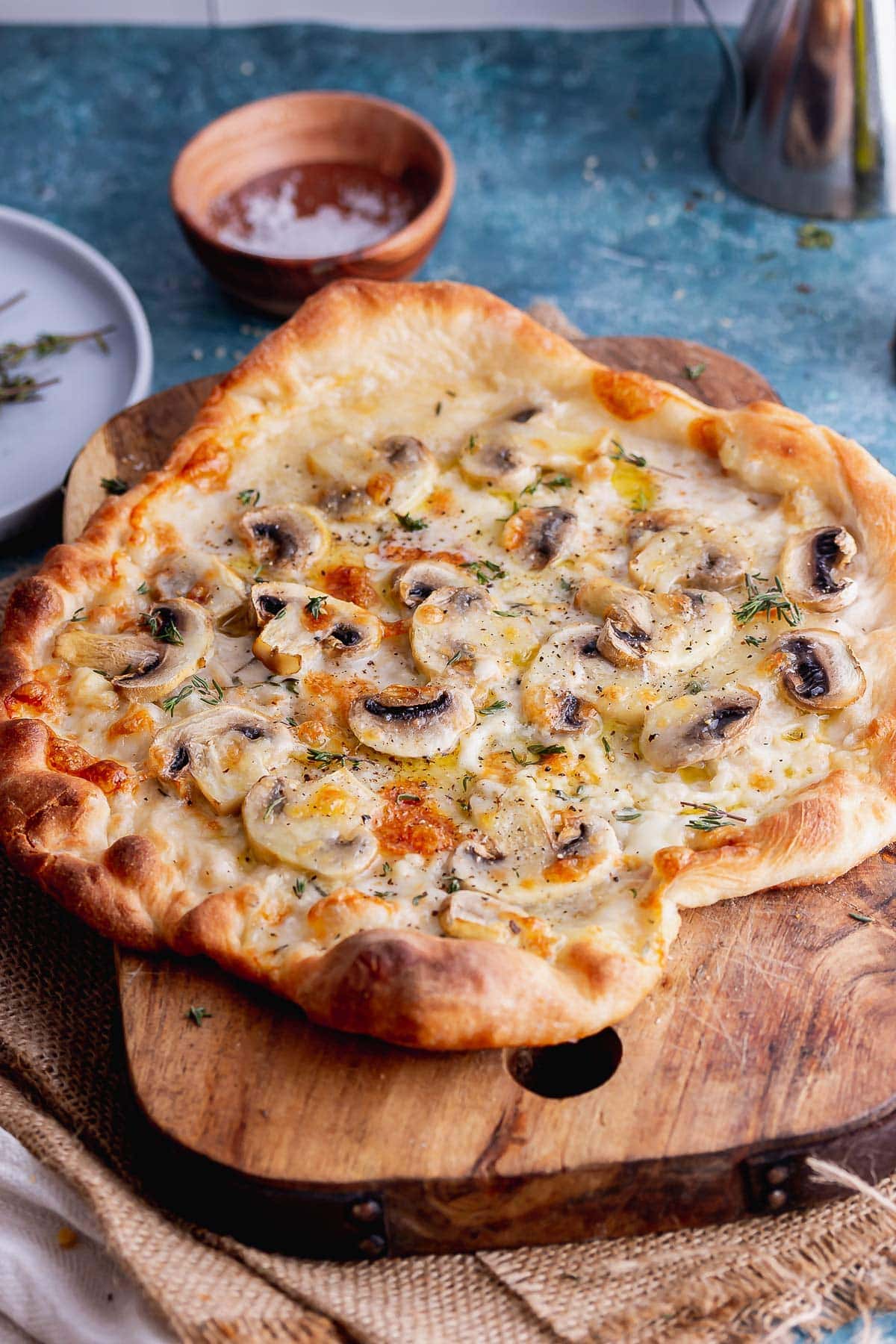 Skillet pizza with mushroom on a wooden board