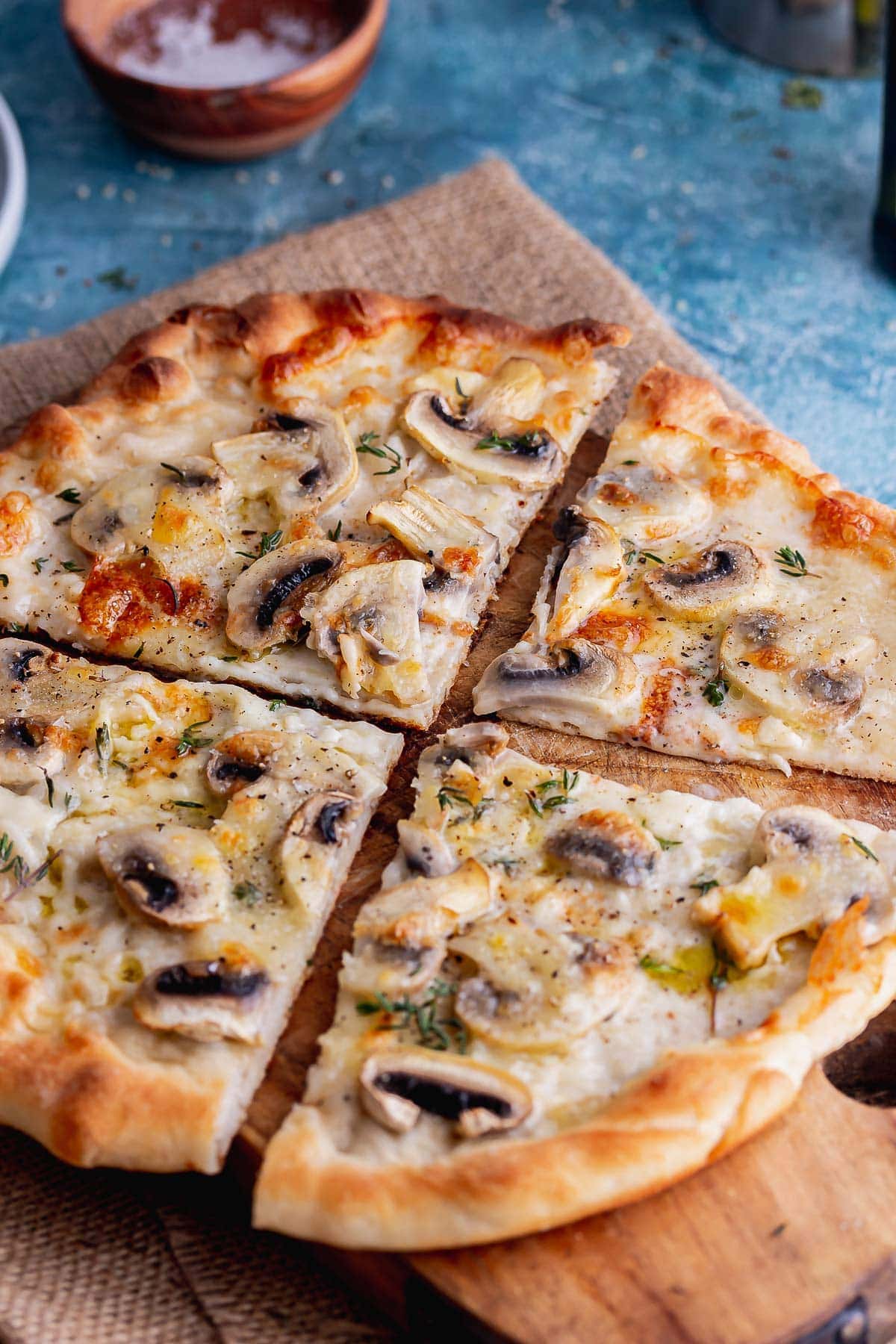 Pizza cut into quarters on a wooden board