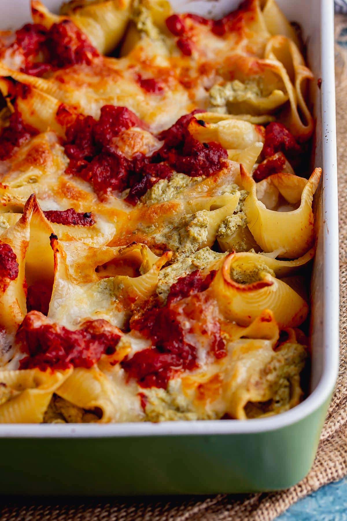 Close up of stuffed pasta shells in a baking dish