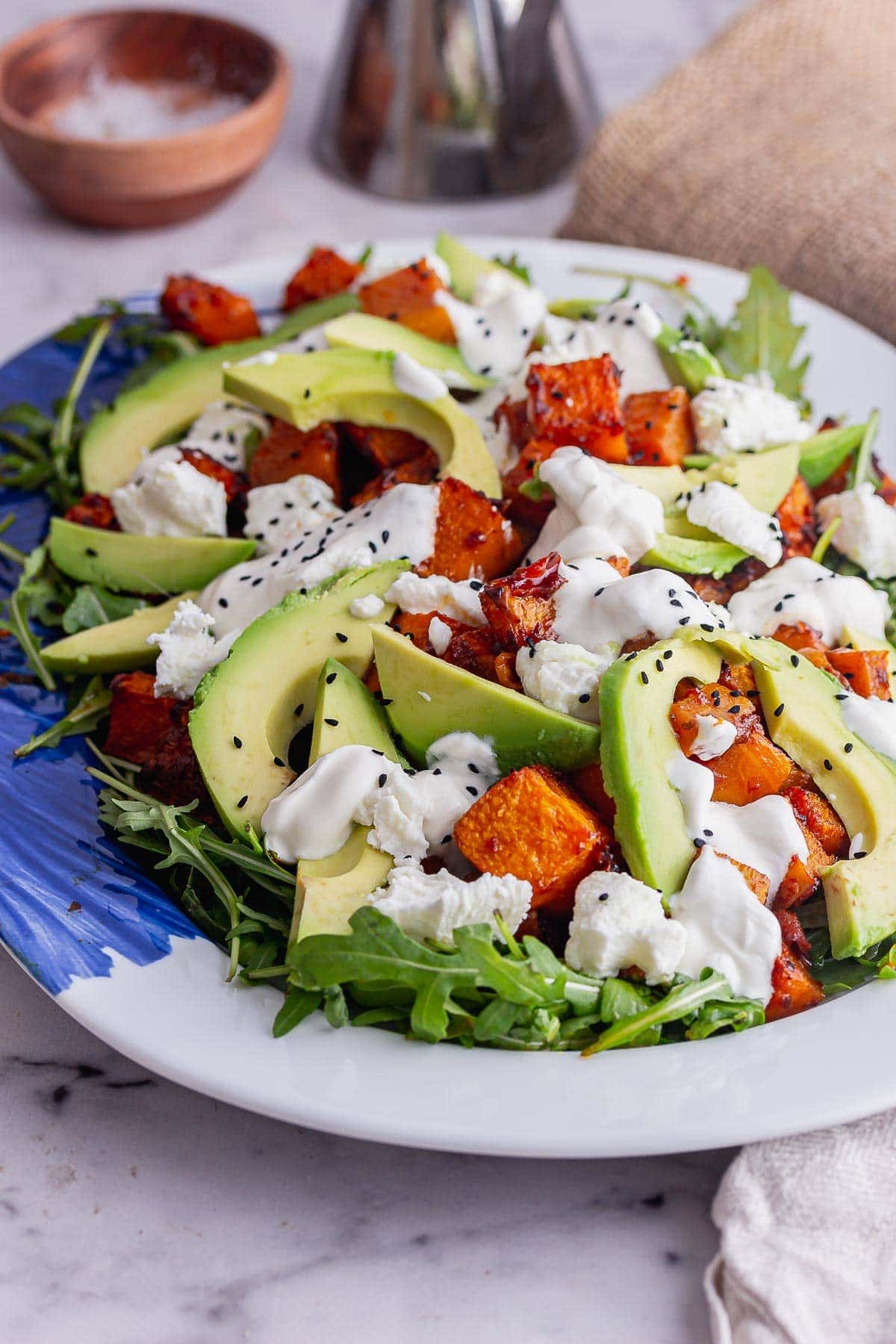 White platter of winter salad on a marble surface