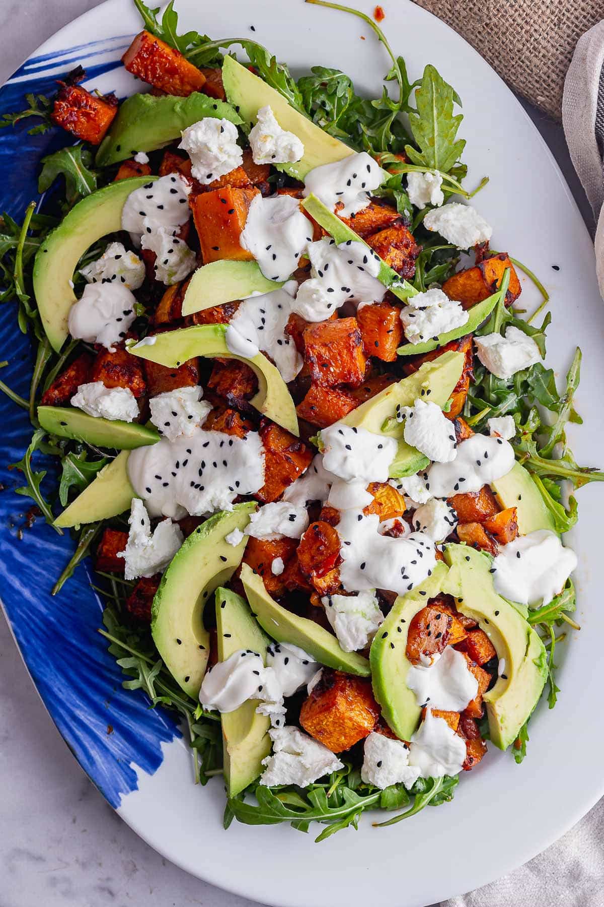 Winter salad on a white and blue serving platter