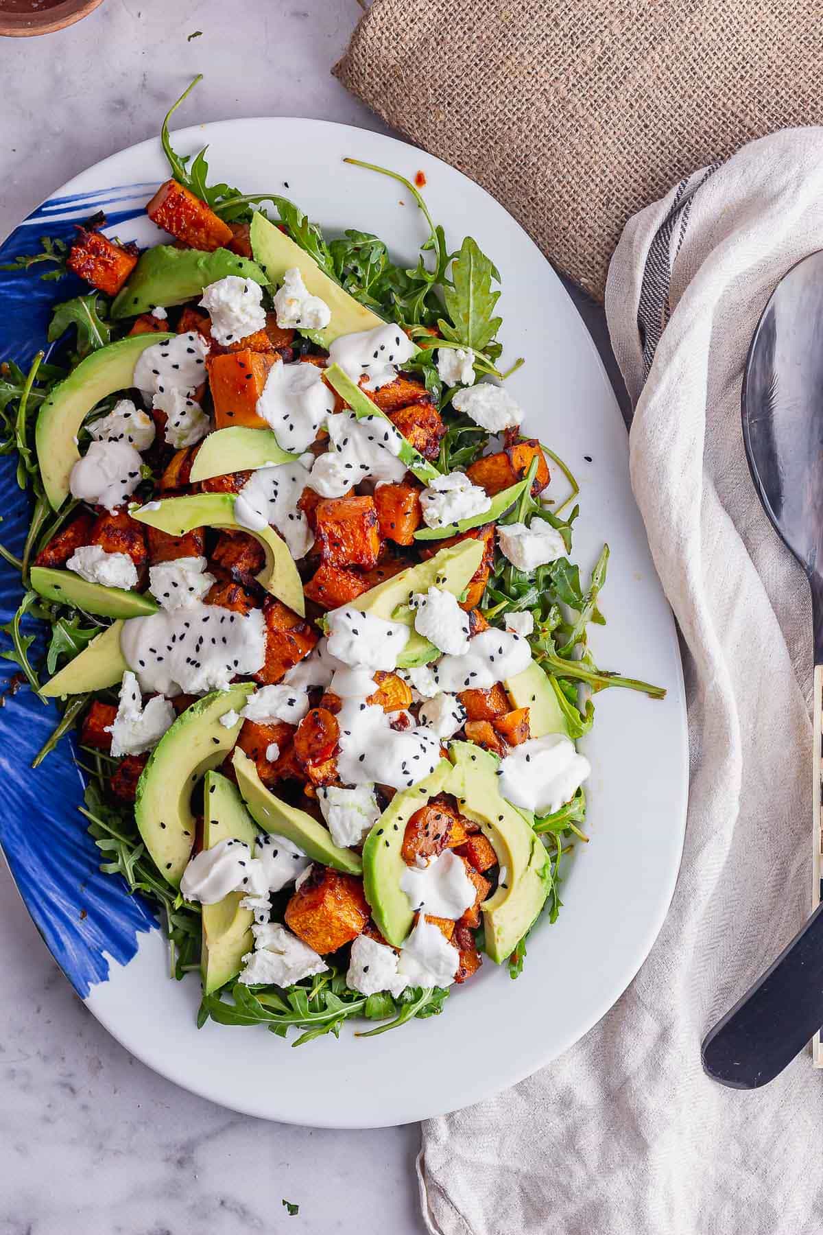 Overhead shot of winter salad on a white and blue plate