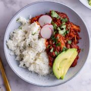 Overhead shot of chicken chilli with avocado and rice