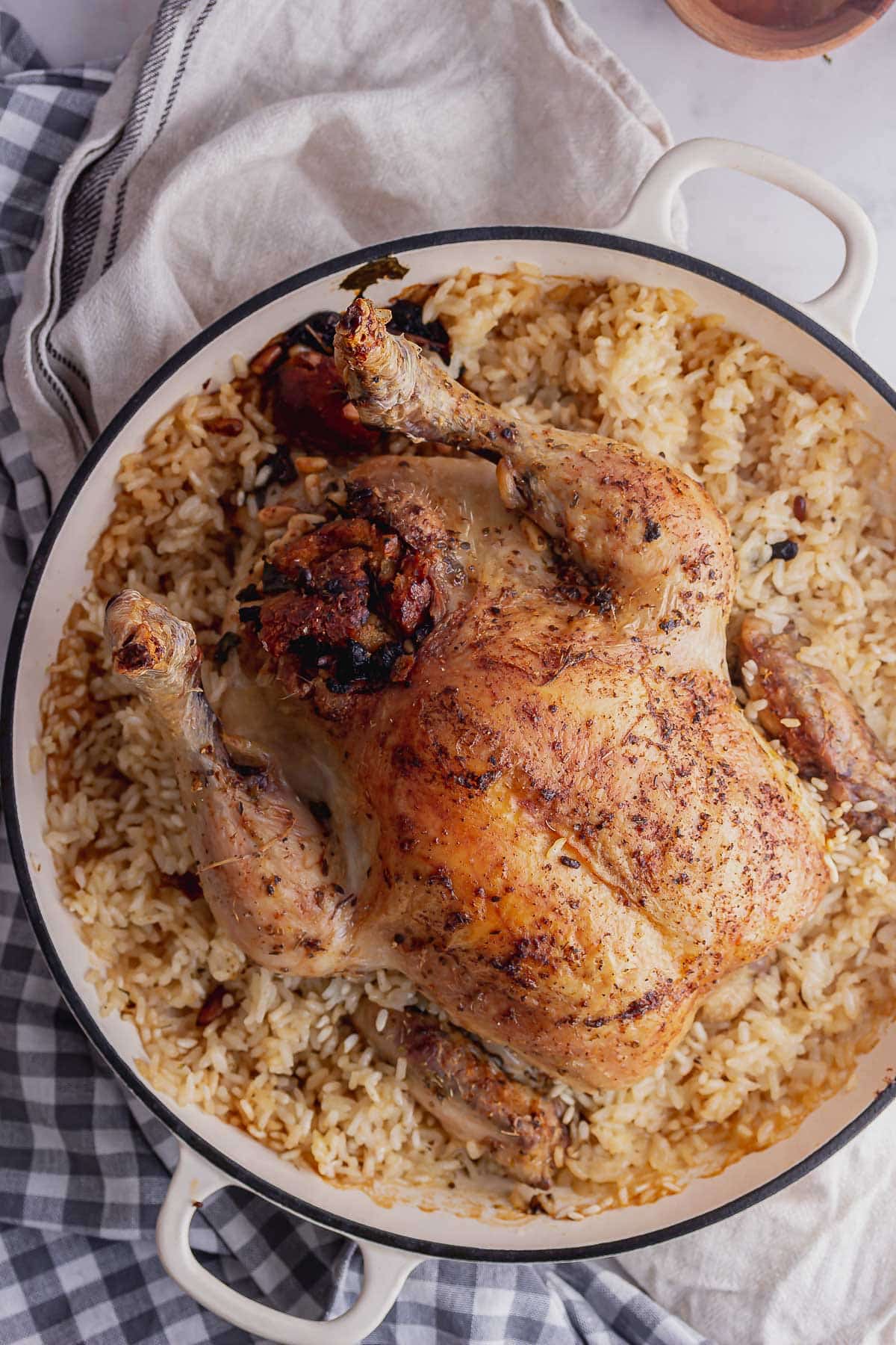 Overhead shot of stuffed chicken on risotto on a marble background