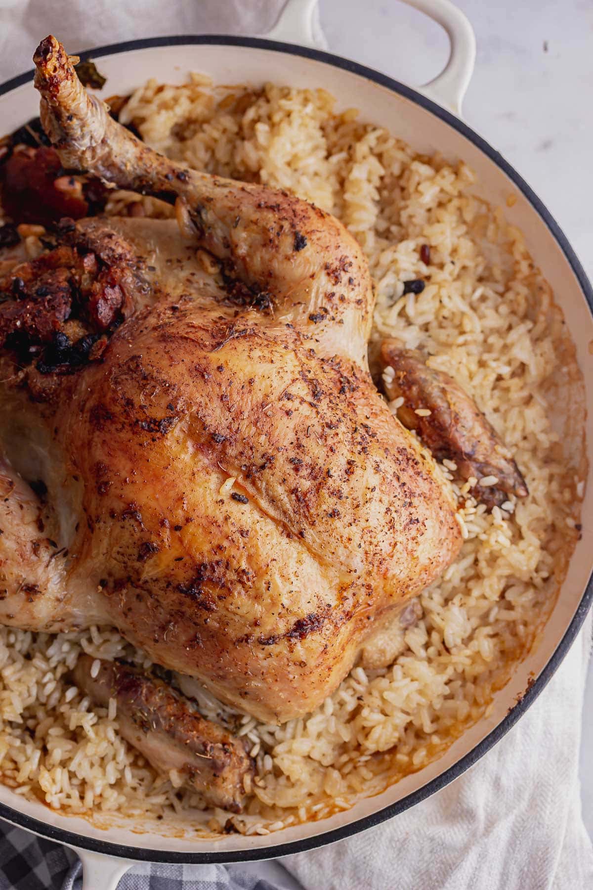 Overhead shot of roast chicken risotto in a white dish