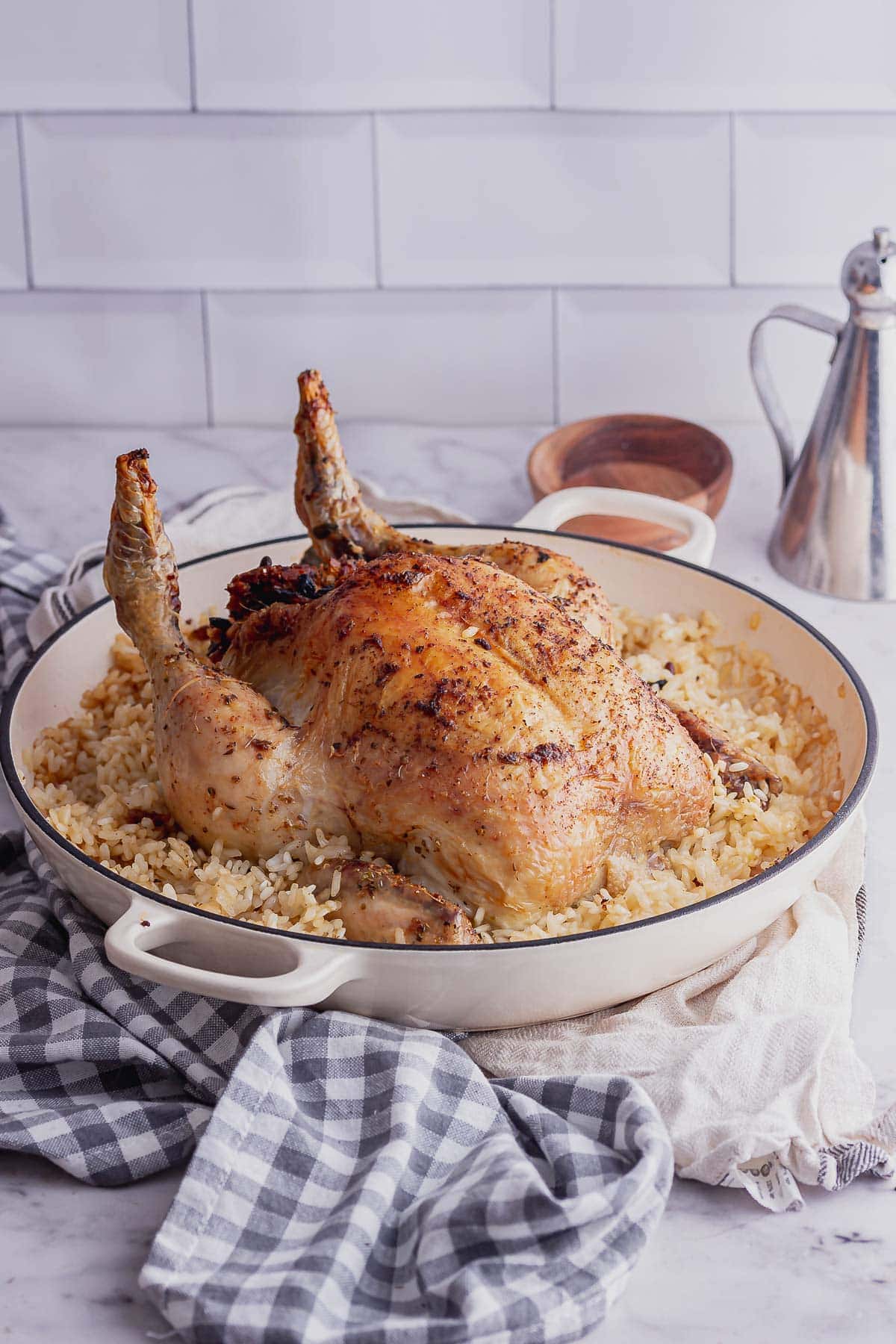 White dish of stuffed chicken and risotto on a checked cloth