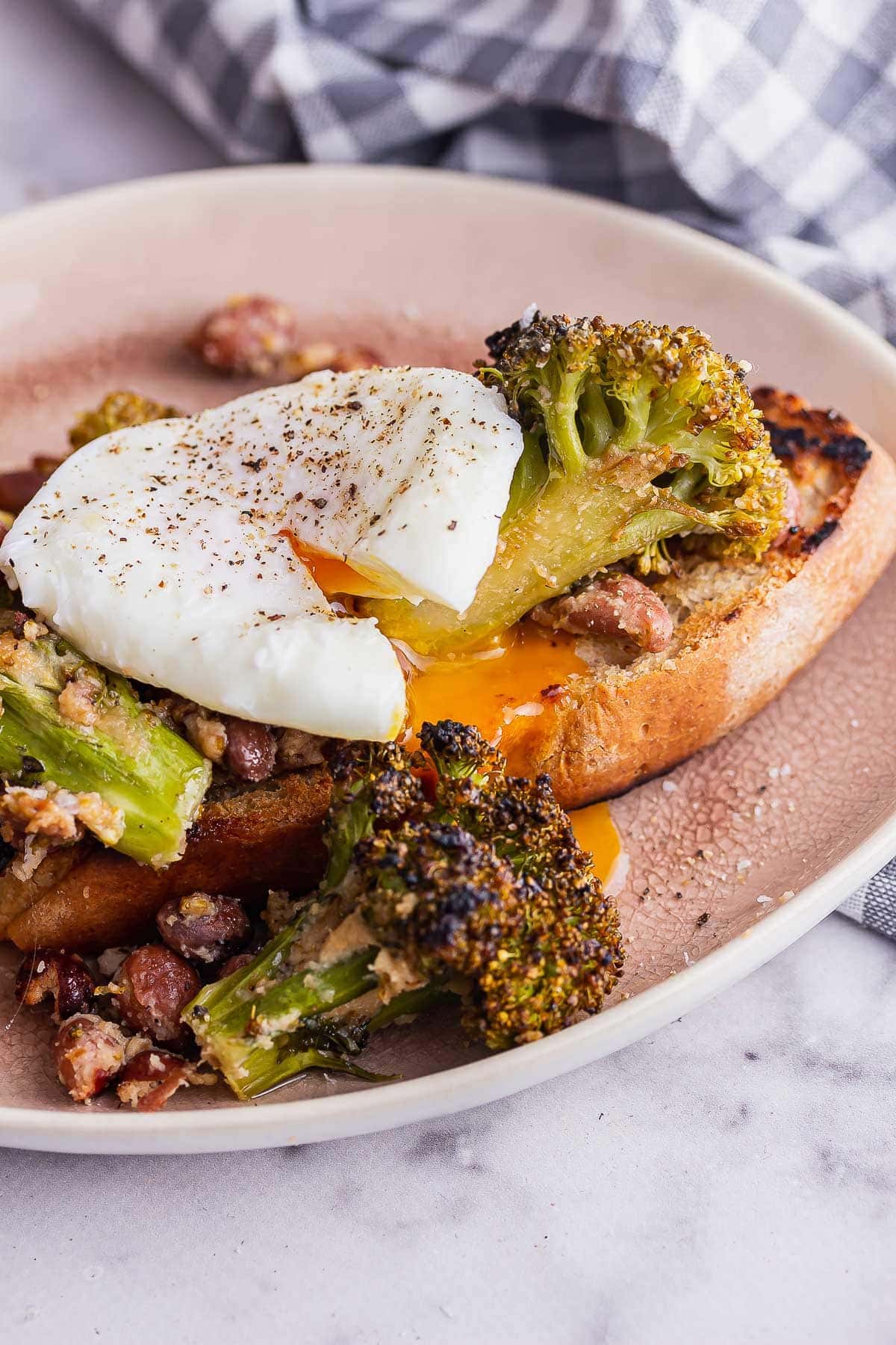 Roasted broccoli and beans on toast with a poached egg