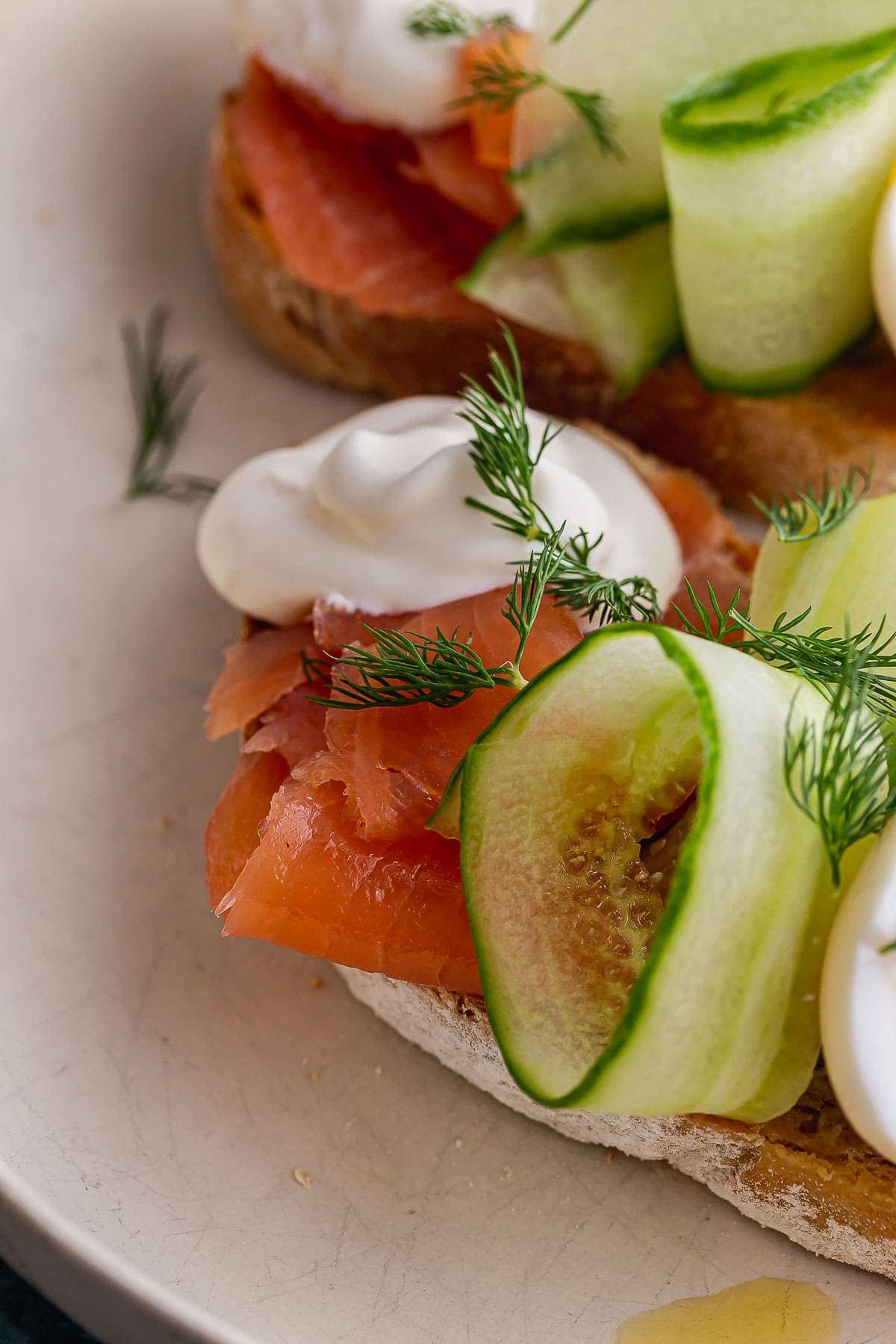 Close up of smoked salmon, cucumber and creme fraiche on toast