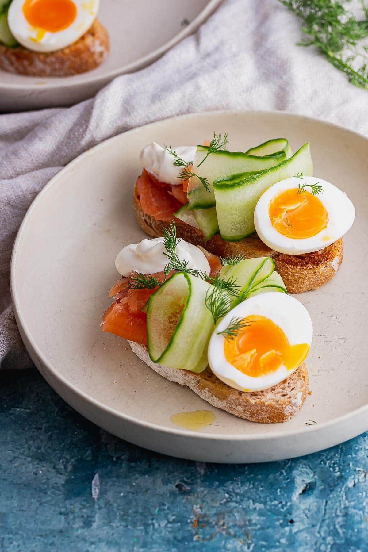 Close up of salmon breakfast toasts on a blue background