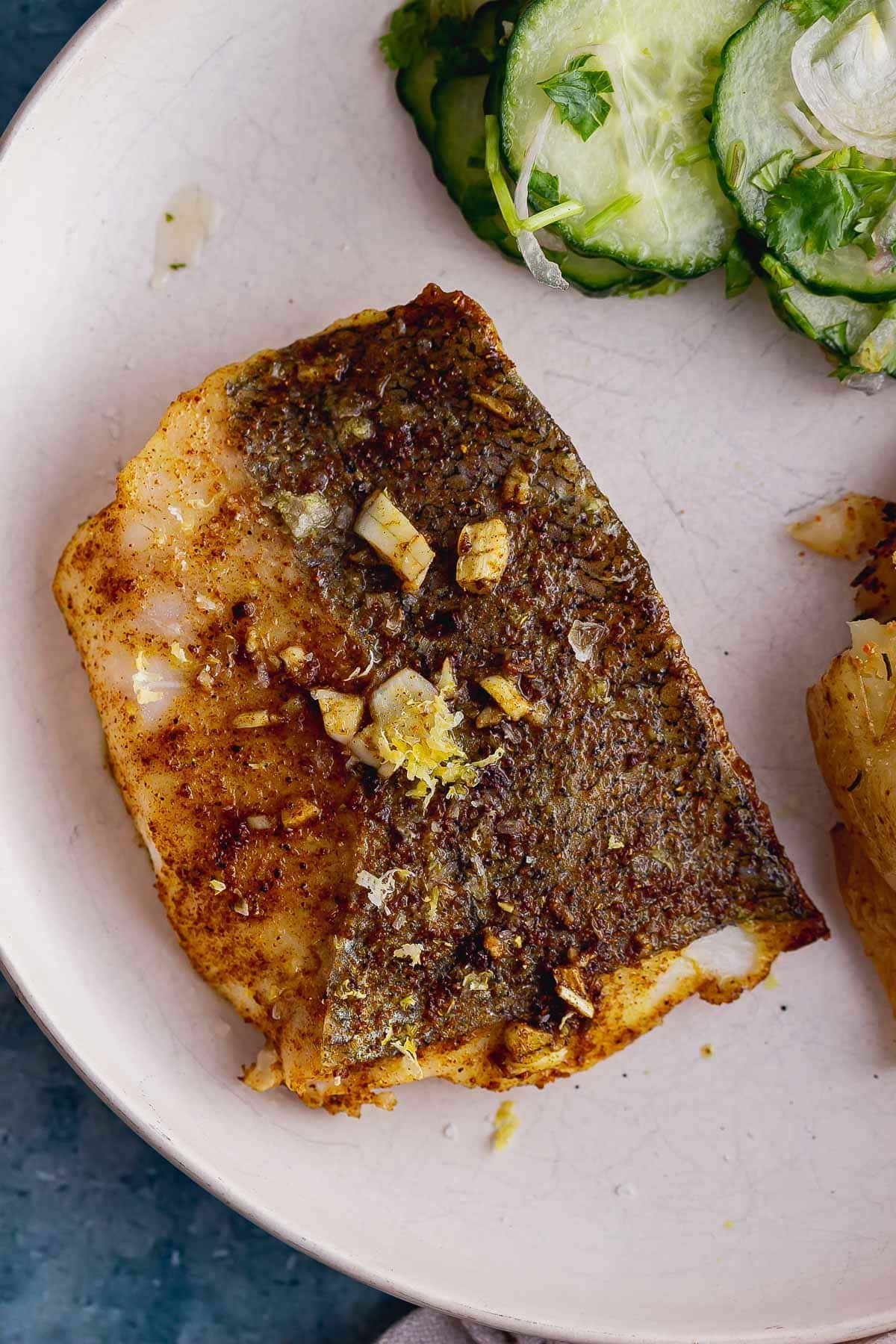 Overhead shot of a fish fillet on a white plate