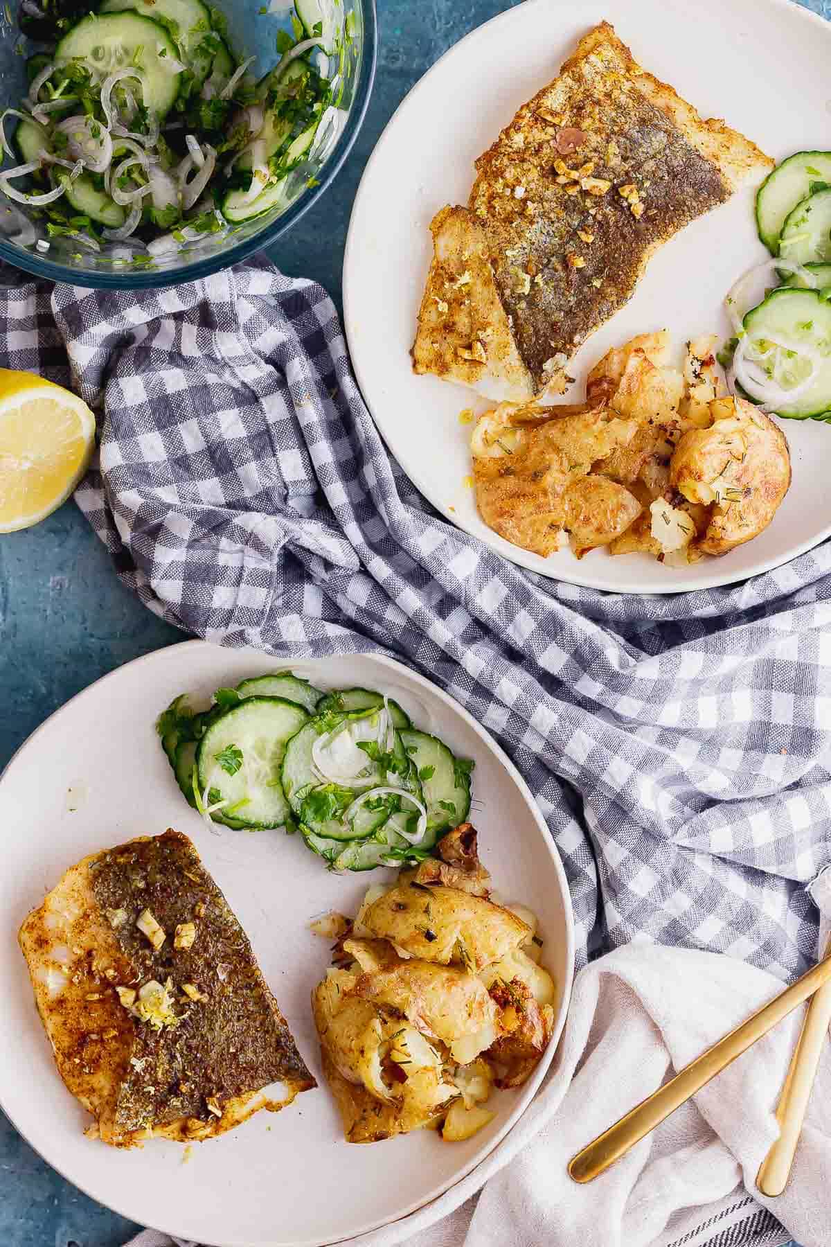 Overhead shot of two bowls of spiced fish with a checked cloth