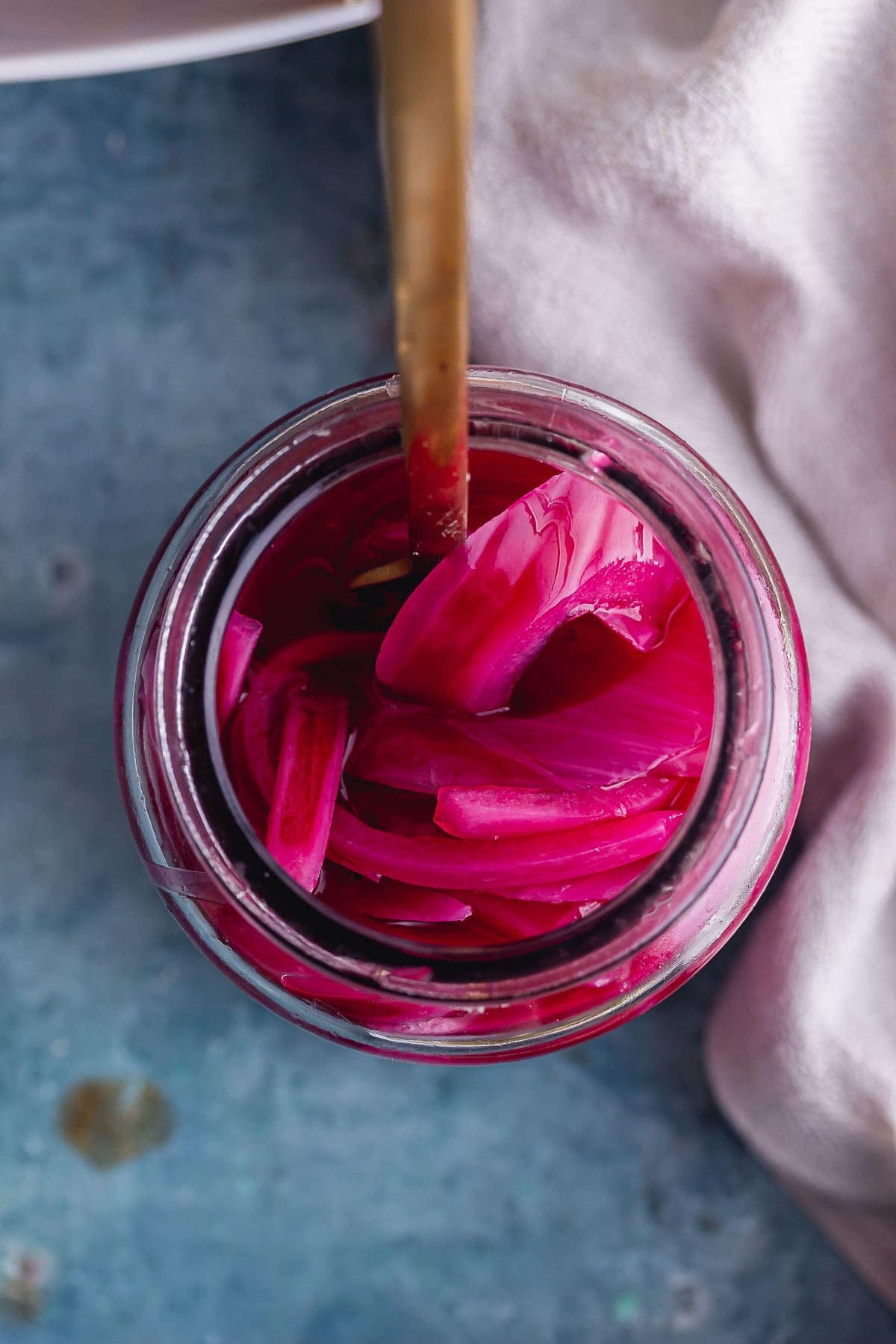Overhead shot of a jar of pink pickled onions