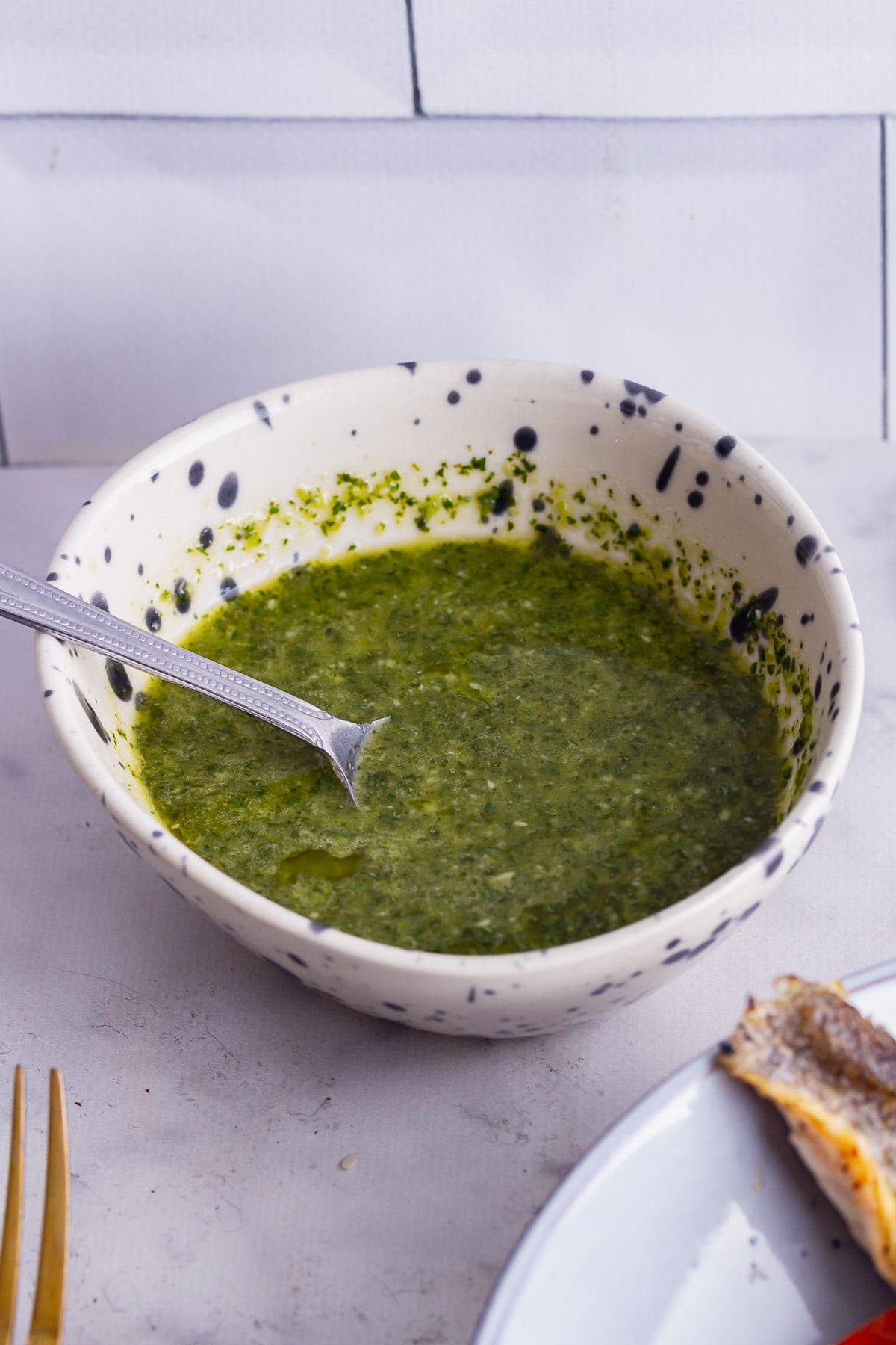 Coriander sauce in small speckled bowl