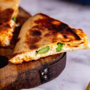 Close up of cheese and broccoli in flatbreads