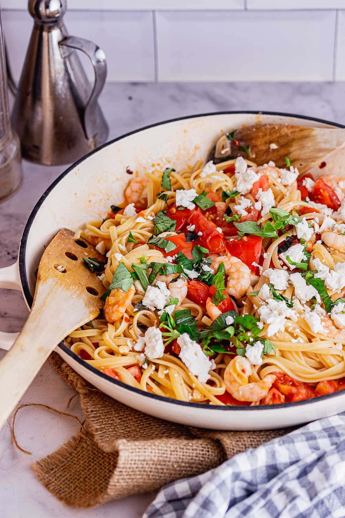 Dish of pasta with tomatoes and feta on a hessian mat