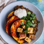 Overhead shot of squash and paneer on lentils