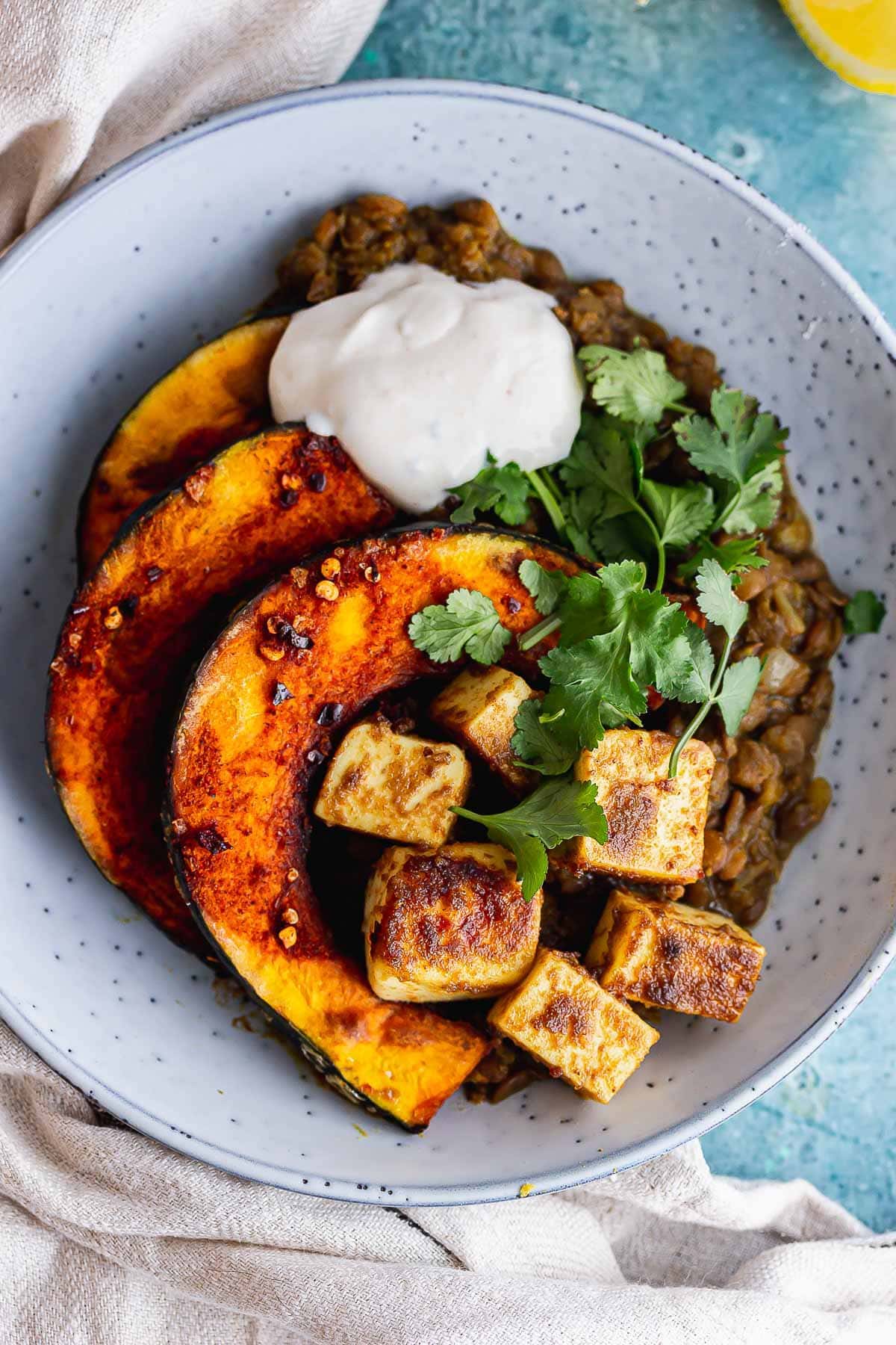 Overhead shot of spicy lentils with squash and paneer