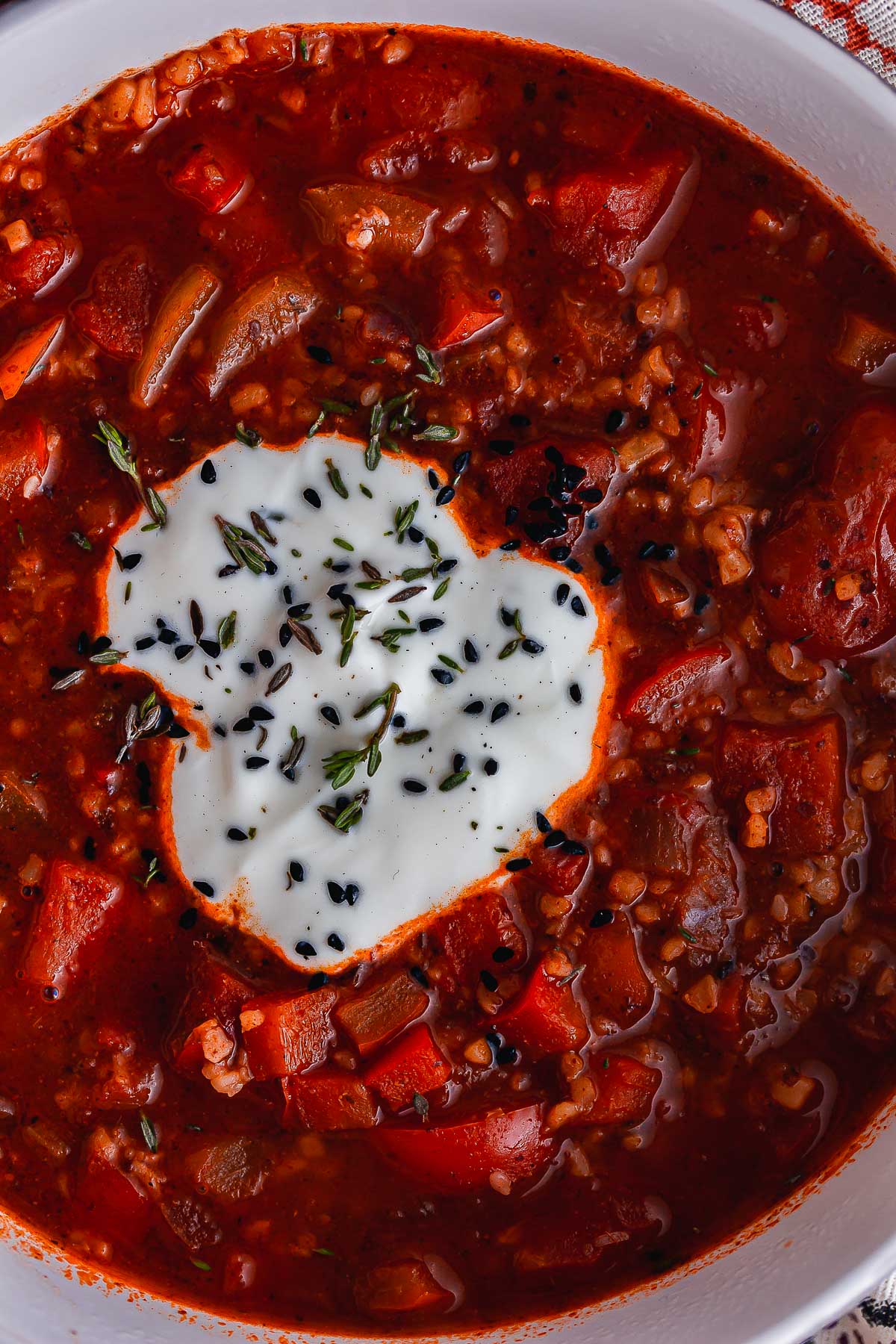 Close up of vegan tomato soup topped with yoghurt