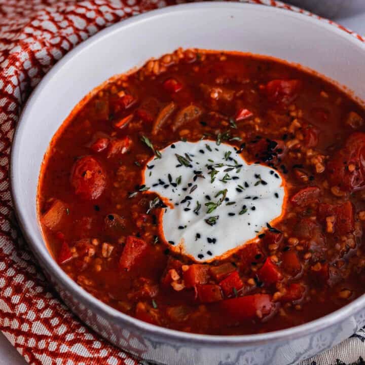 spiced soup with tomato topped with yoghurt
