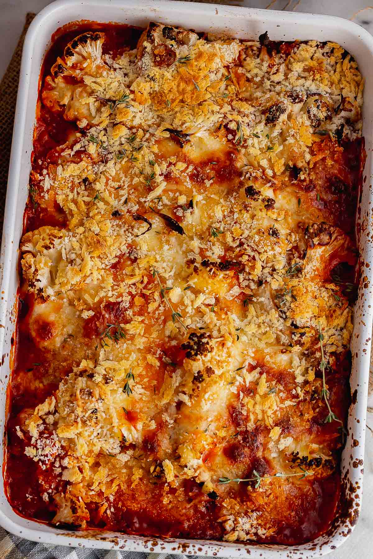 Overhead shot of cheesy cauliflower and tomato bake