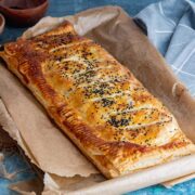 Vegetarian roll on baking paper on a blue background