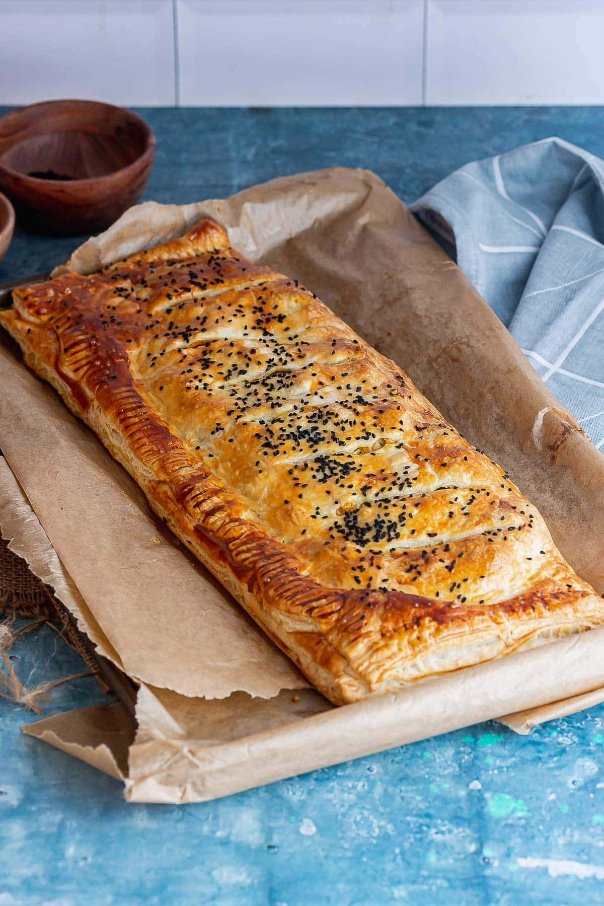 Vegetarian roll on baking paper on a blue background