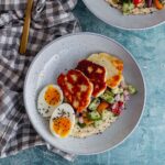 Overhead shot of halloumi breakfast bowl on a checked cloth