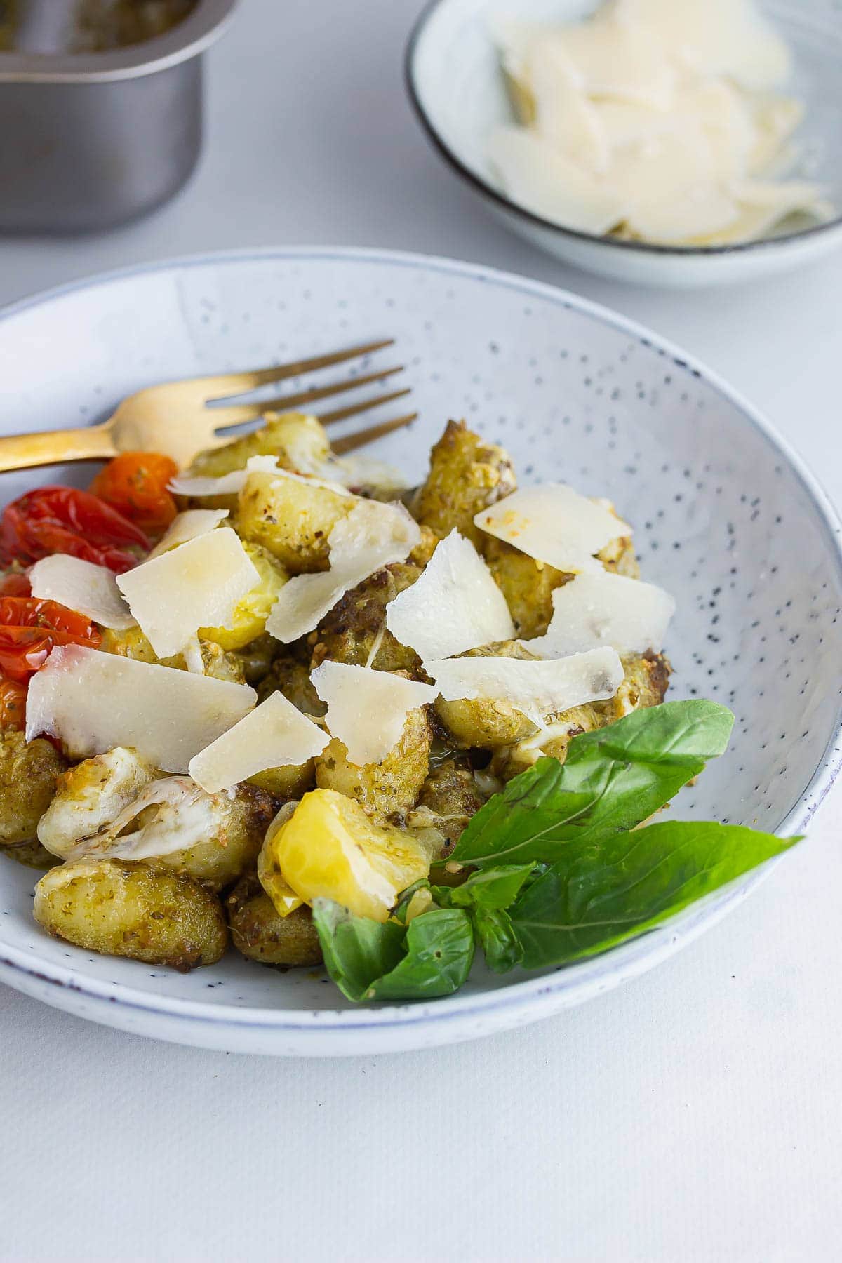 Blue bowl of gnocchi with a gold fork