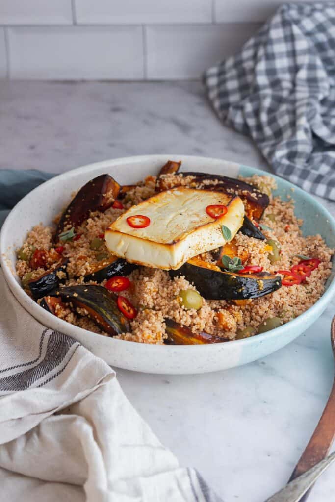 Serving platter of couscous salad on a marble surface