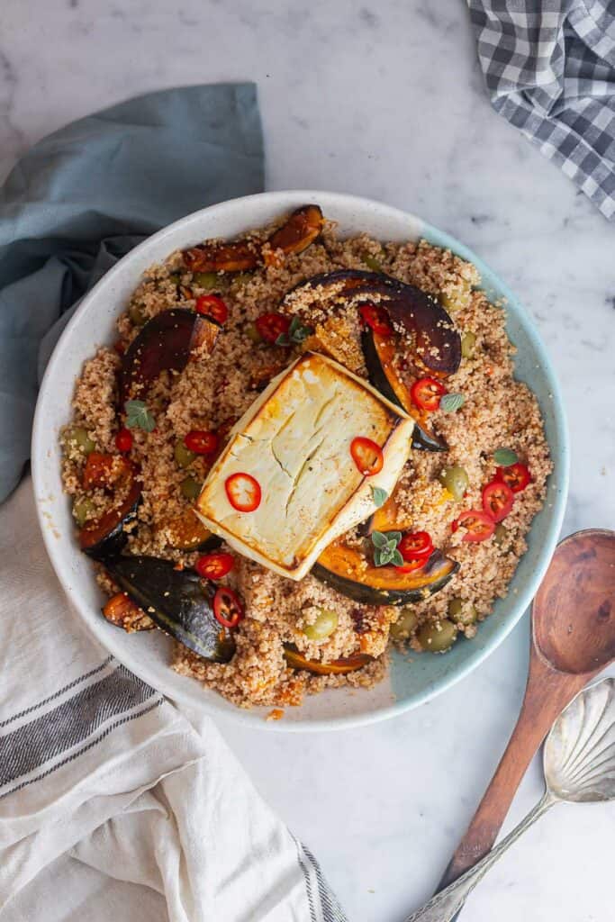 Overhead shot of a serving platter of couscous on a marble surface