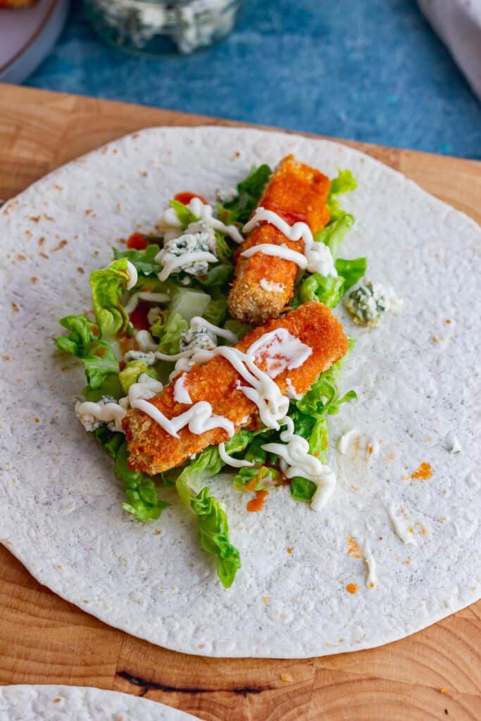 Tofu with salad in a wrap on a wooden board