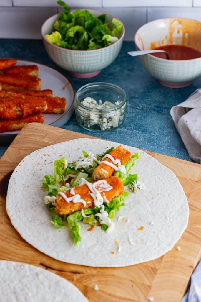 Wrap topped with buffalo tofu and salad