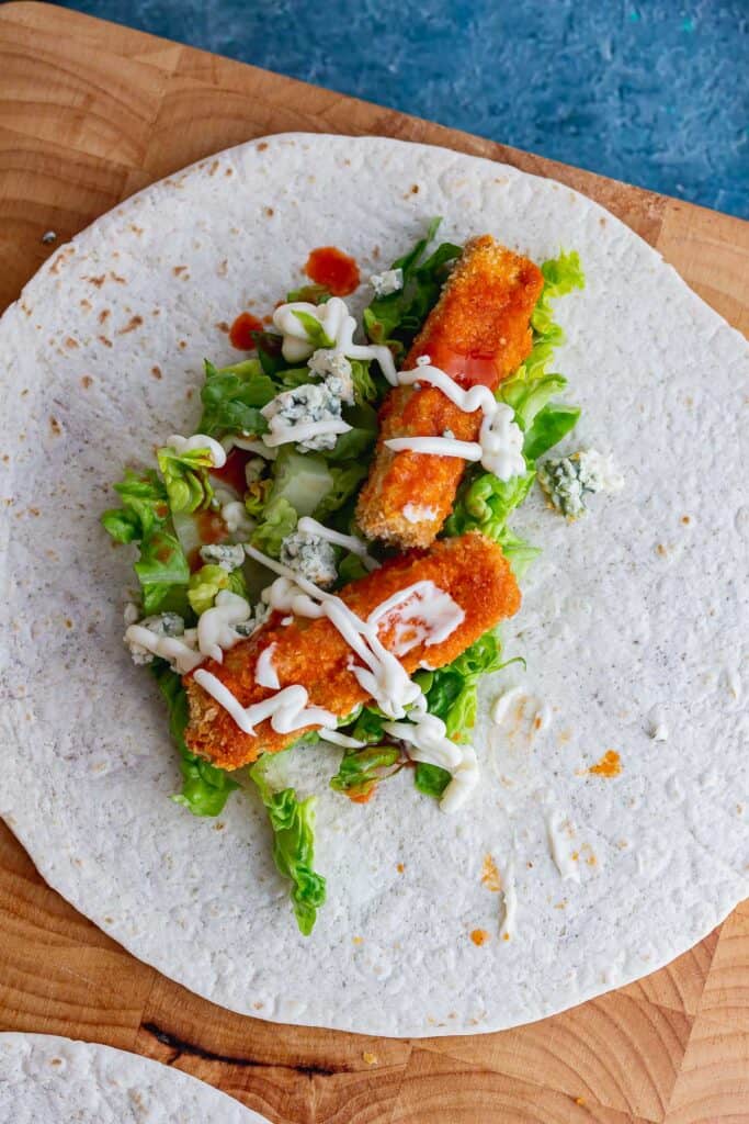 Overhead shot of buffalo tofu with lettuce on a wrap