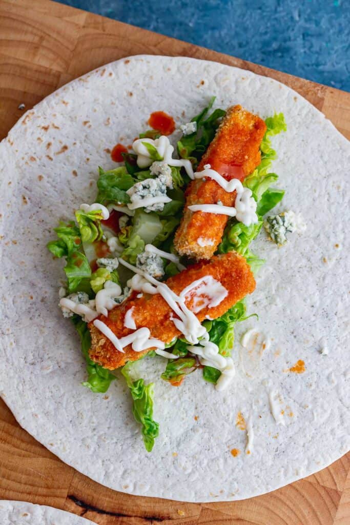 Overhead shot of buffalo tofu and salad on a wrap