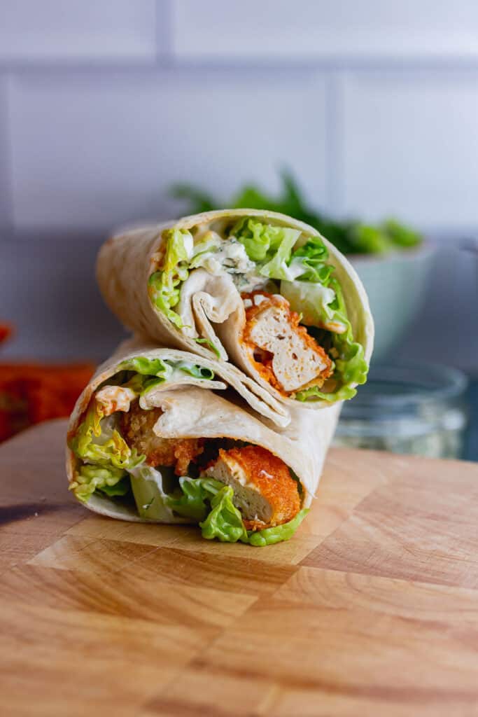 Tofu wraps with lettuce on a wooden board