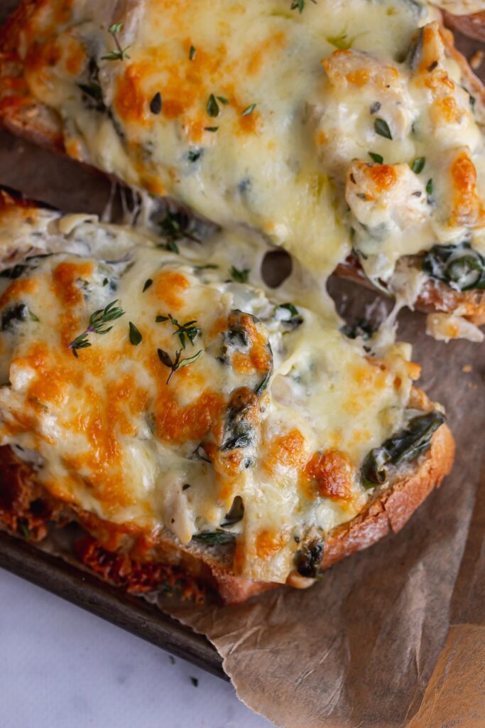 Close up of artichoke spinach toast 
