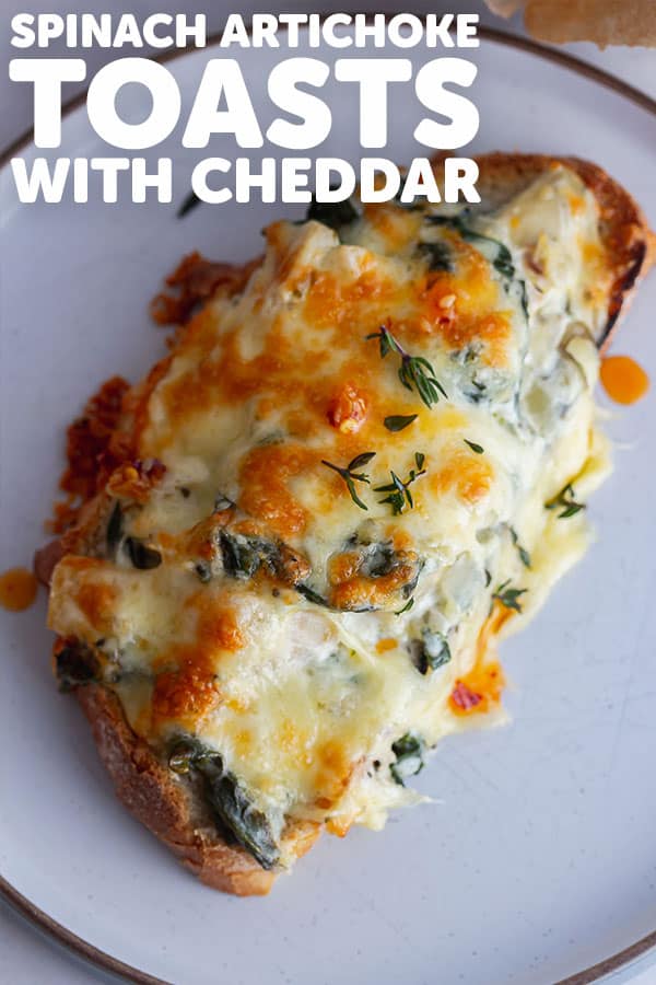 Pinterest image for spinach artichoke toasts with text overlay