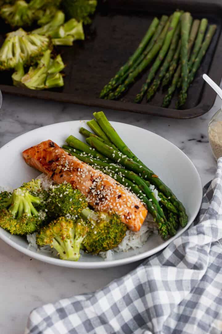 Bowl of salmon, vegetables and rice with a checked cloth