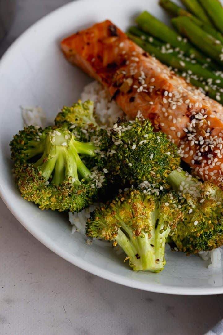 Close up of roasted broccoli in a white bowl