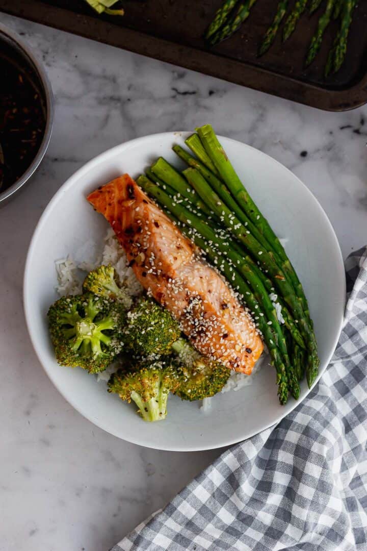 Overhead shot of salmon and vegetables on a marble background