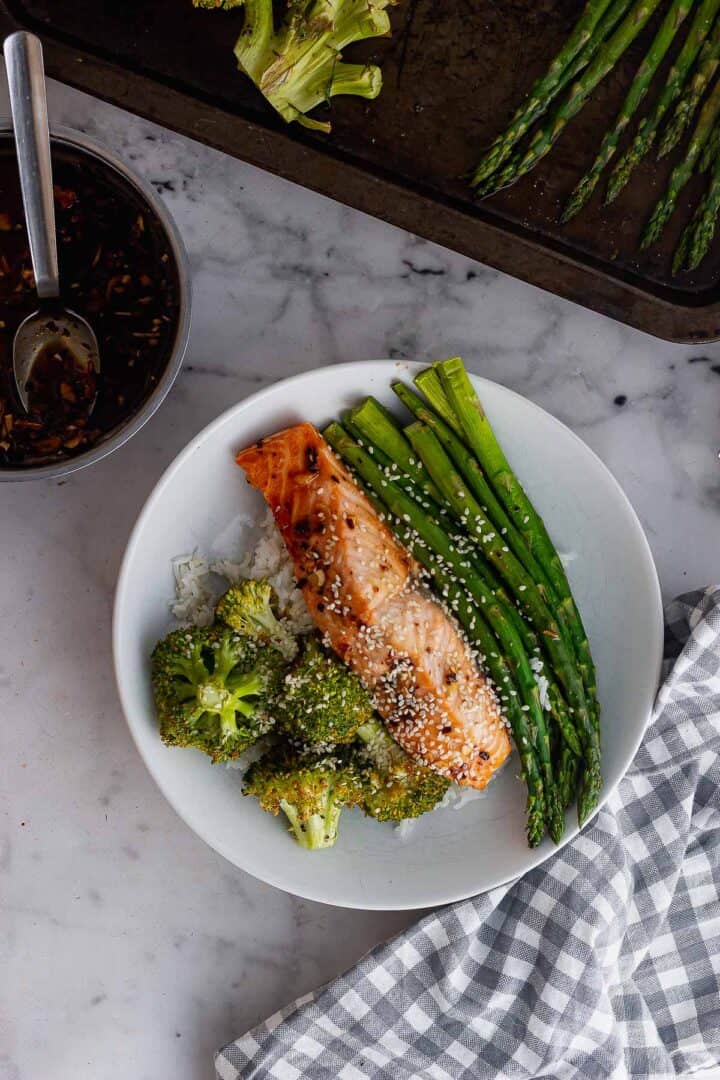 Overhead image of salmon in a white bowl on a marble background