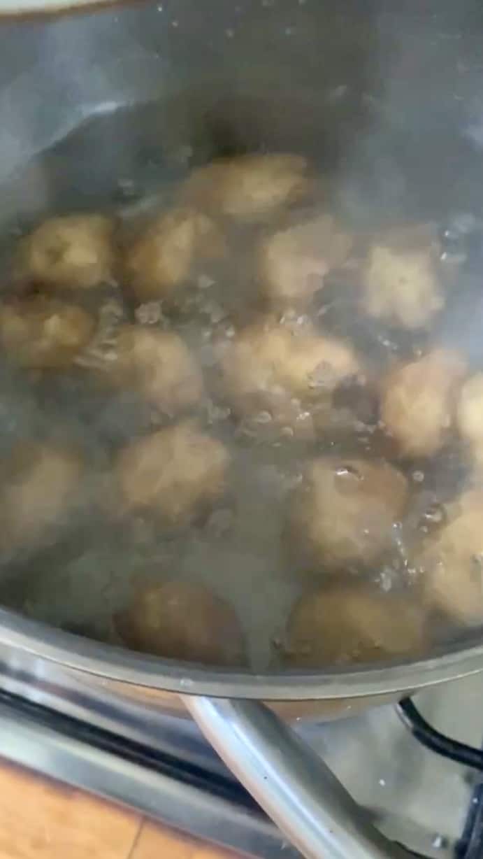Silver pot of potatoes boiling