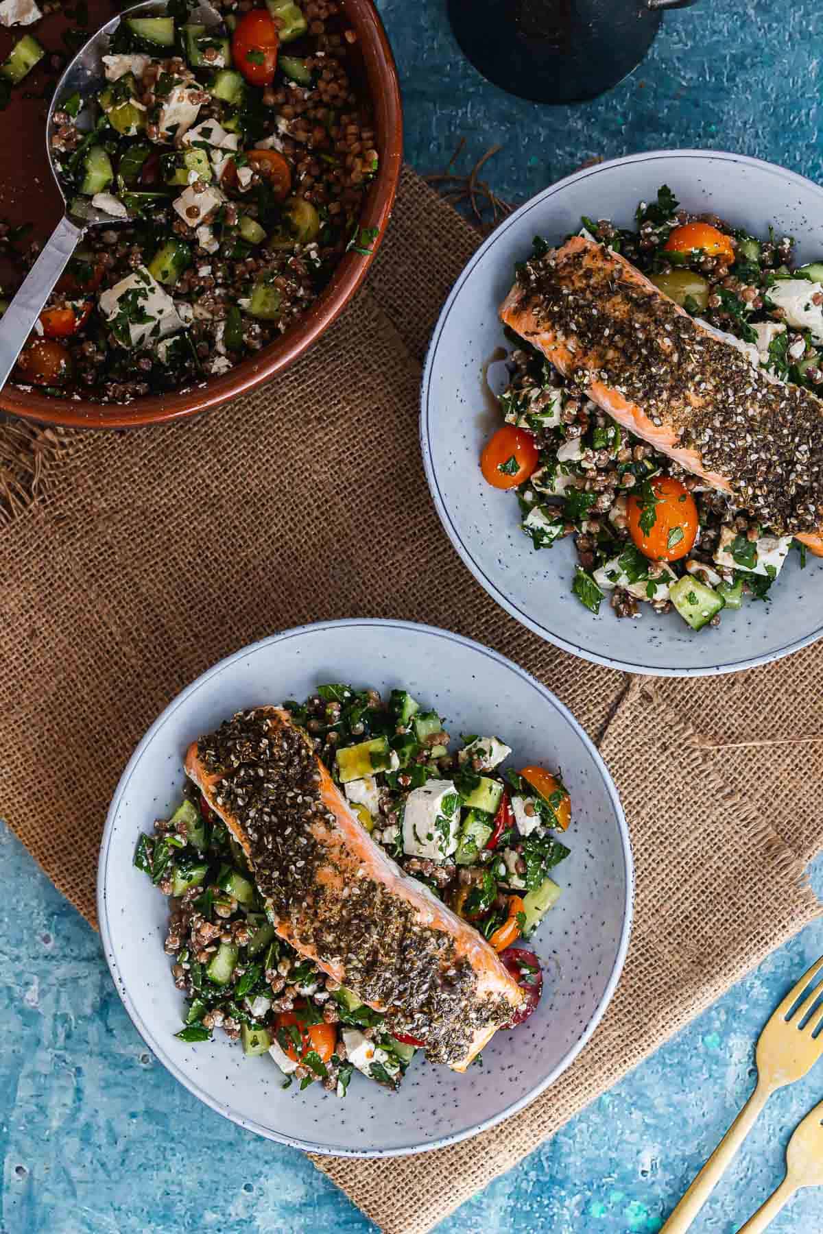 Overhead shot of salmon and couscous on a woven mat