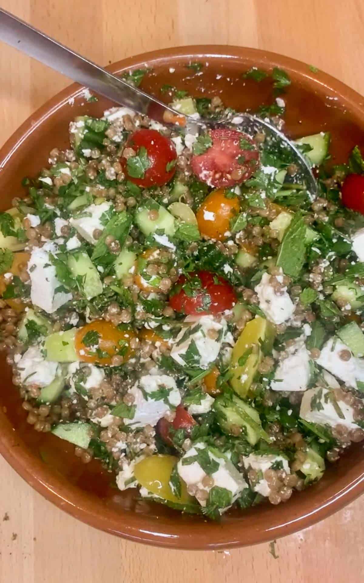 Couscous salad in a brown bowl