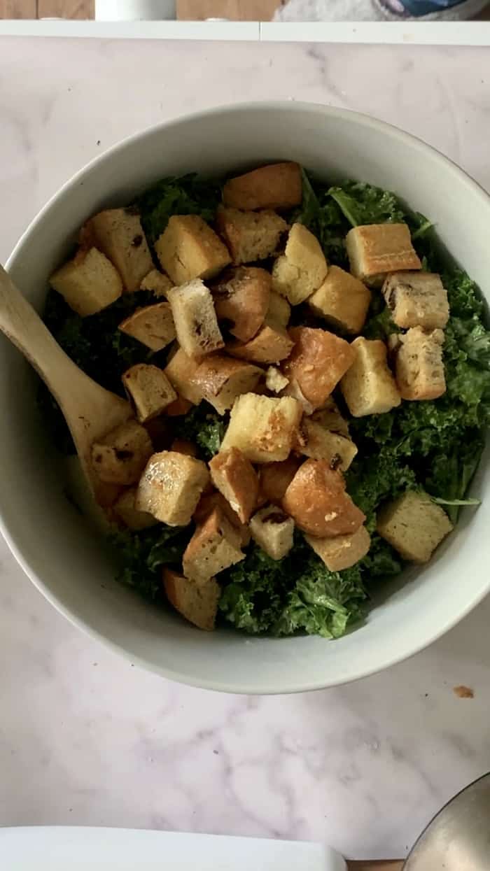 Overhead shot of kale and croutons in a bowl