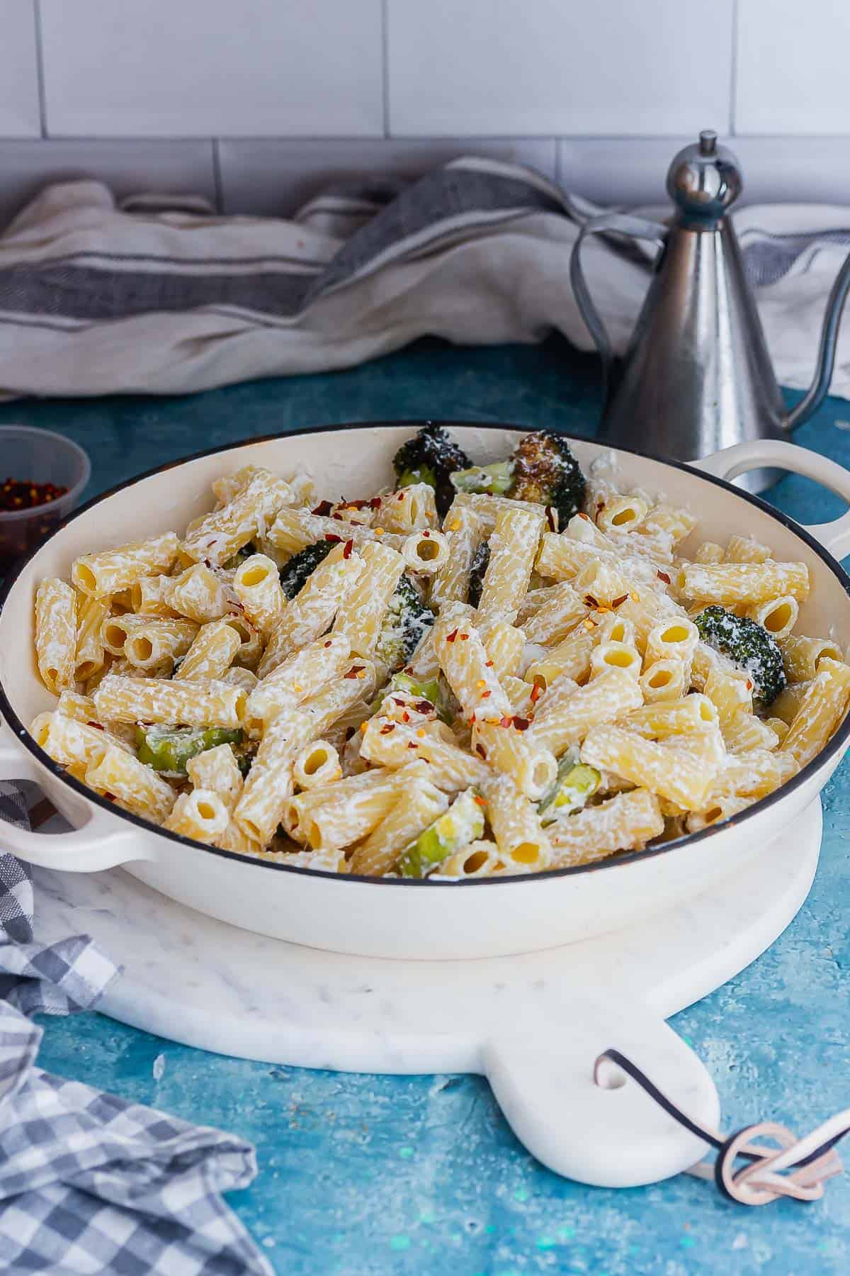 Ricotta pasta with broccoli in a pot on a blue surface
