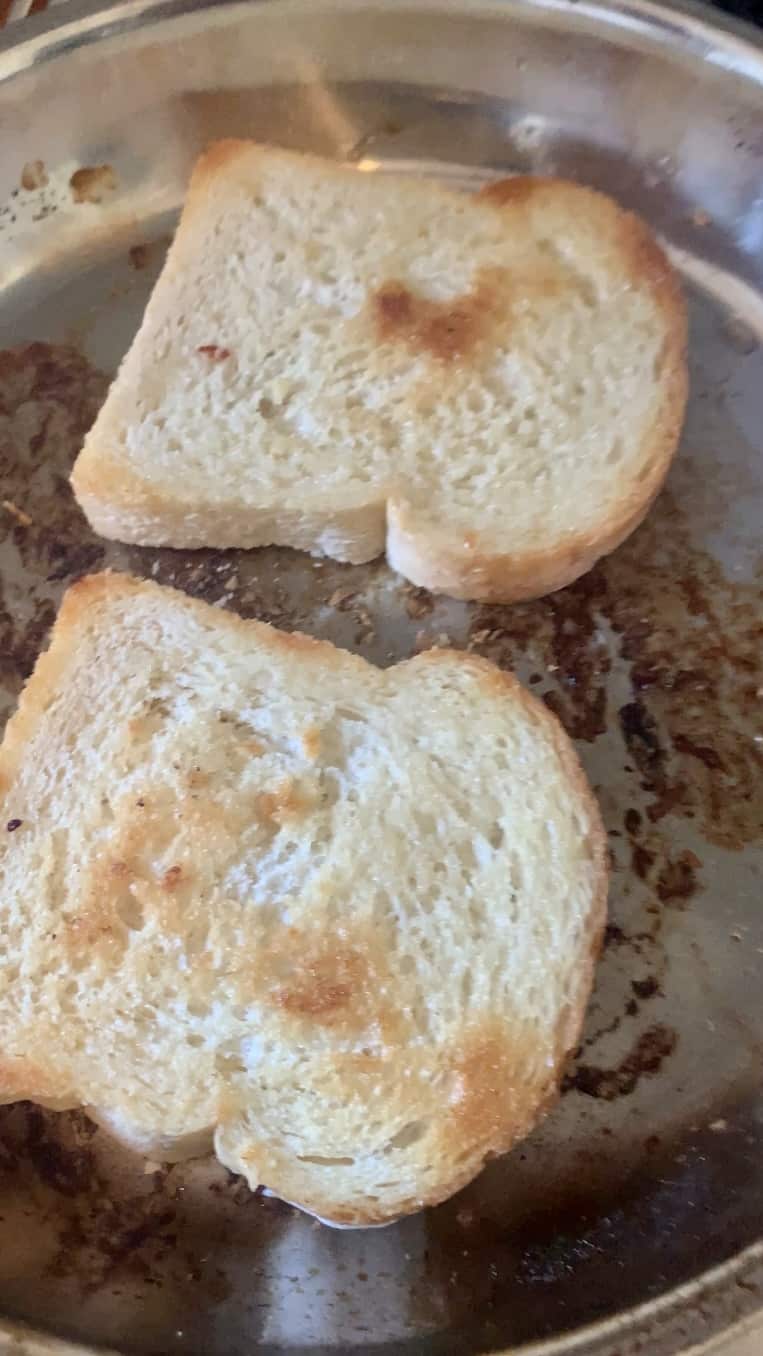 Bread being toasted in a frying pan