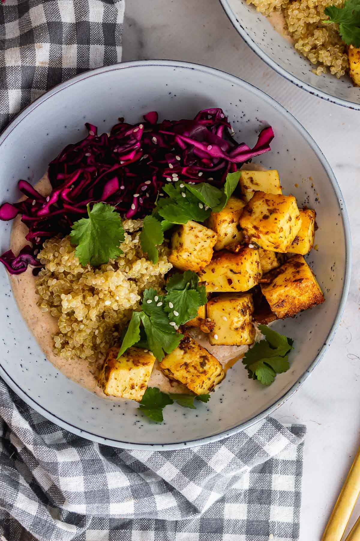 Close up of paneer and quinoa in a blue bowl