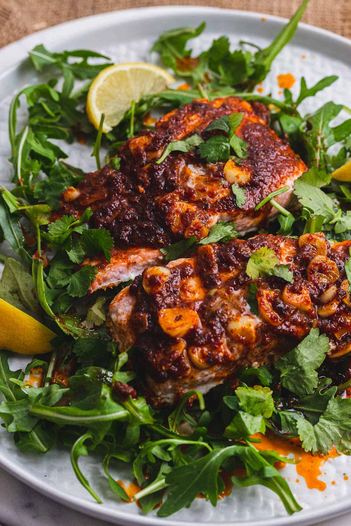 Close up of spicy salmon on a bed of greens